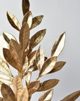 Faux gold bay leaf branches that split off 8 inches up the stem