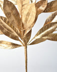 Metallic gold leaf stem made from molded plastic and wire for holiday decorating