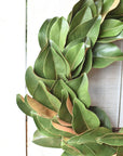 28 inch faux magnolia leaf wreath with glossy two-tone green leaves, full front view