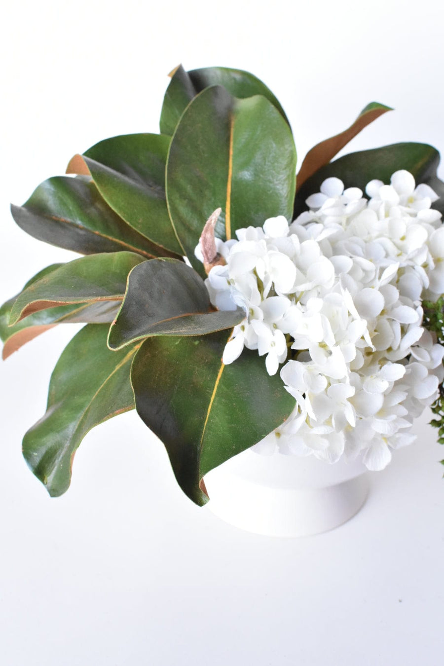 White Hydrangea + Magnolia Leaf Arrangement with Faux Ring Details