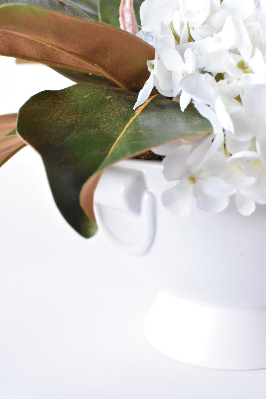 White Hydrangea + Magnolia Leaf Arrangement with Faux Ring Details