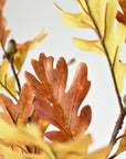 Faux oak branch with brown acorns along the stem