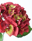 23-inch faux red hydrangea head stem with green accents, full stem view