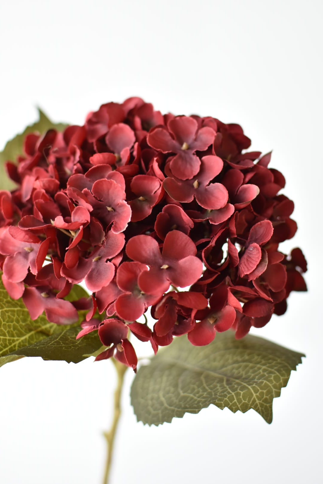 Close-up of a 7-inch deep burgundy faux hydrangea bloom showing individual florets