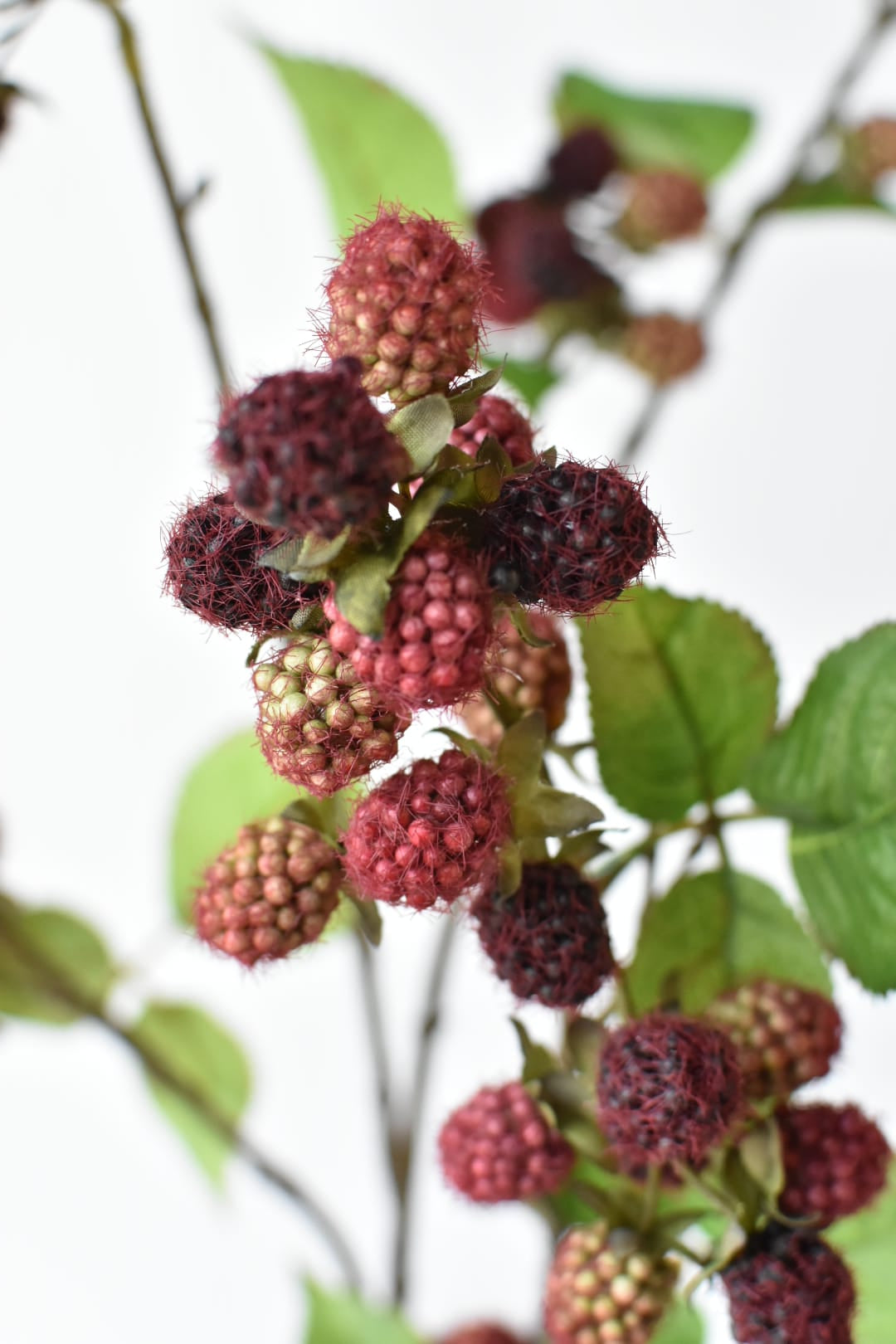 42-inch faux raspberry branch stem with green leaves, full branch view