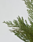 Close-up of faux cedar foliage showing fine clear glitter catching the light