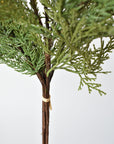 Detail of green faux cedar with clear glitter finish on a wired stem