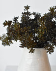 Faux dark brown sedum bundles in a vase showing berry texture and depth