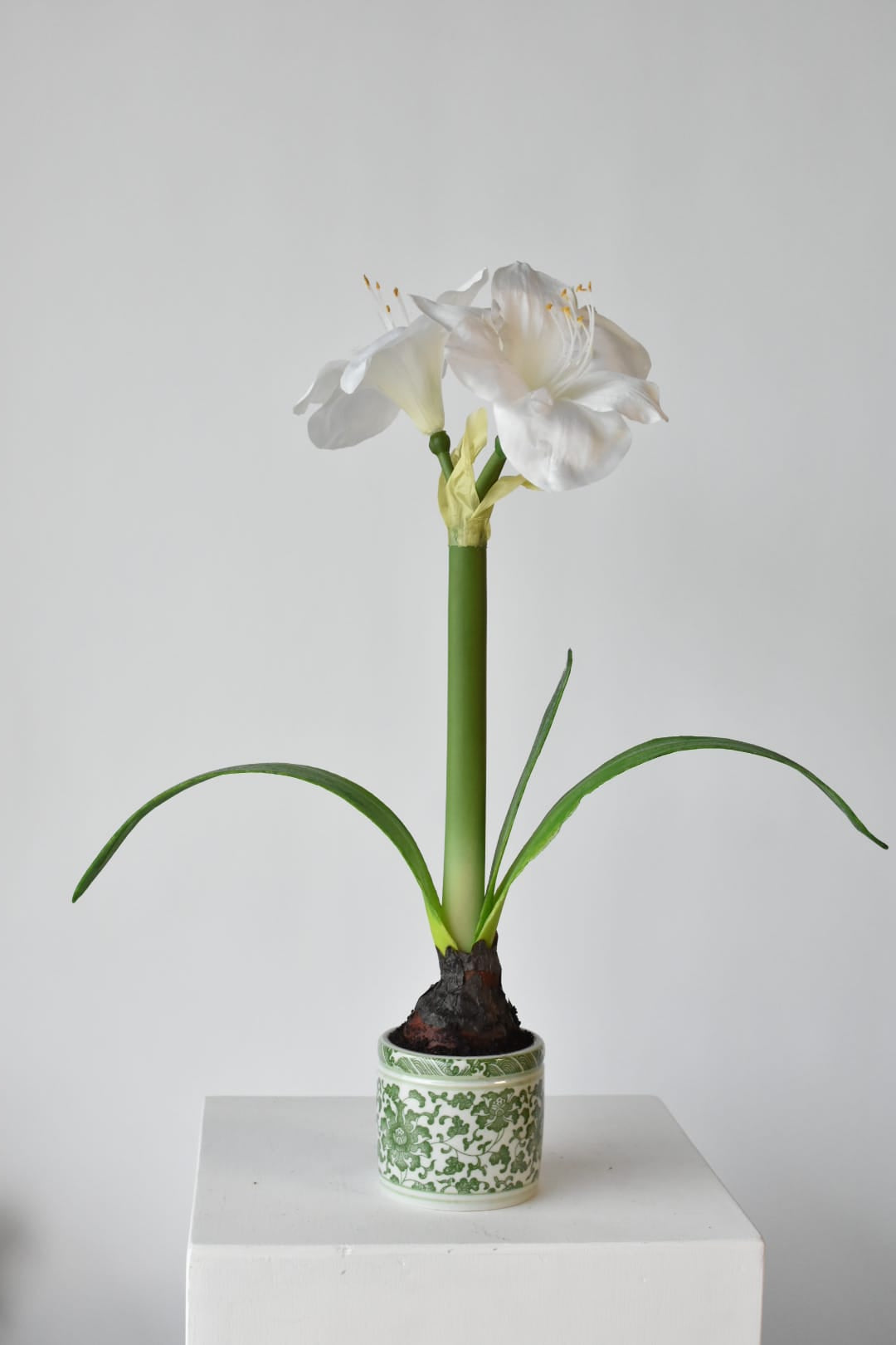 Faux white amaryllis in a green porcelain pot, 20 inches tall
