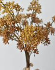 Faux beige sedum bundle held in hand showing the rope-tied base