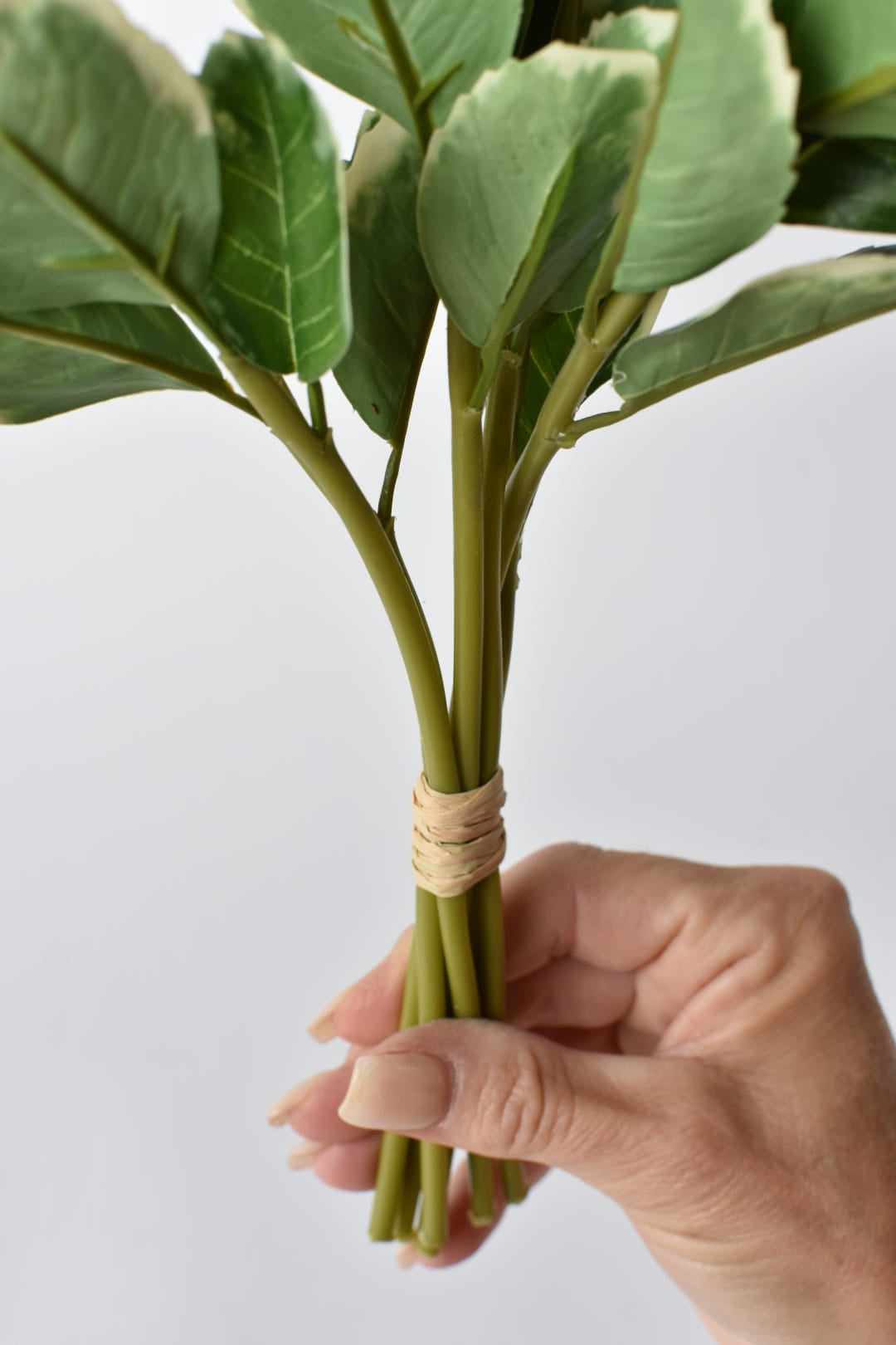 Six-stem faux variegated holly bundle shown from a second angle