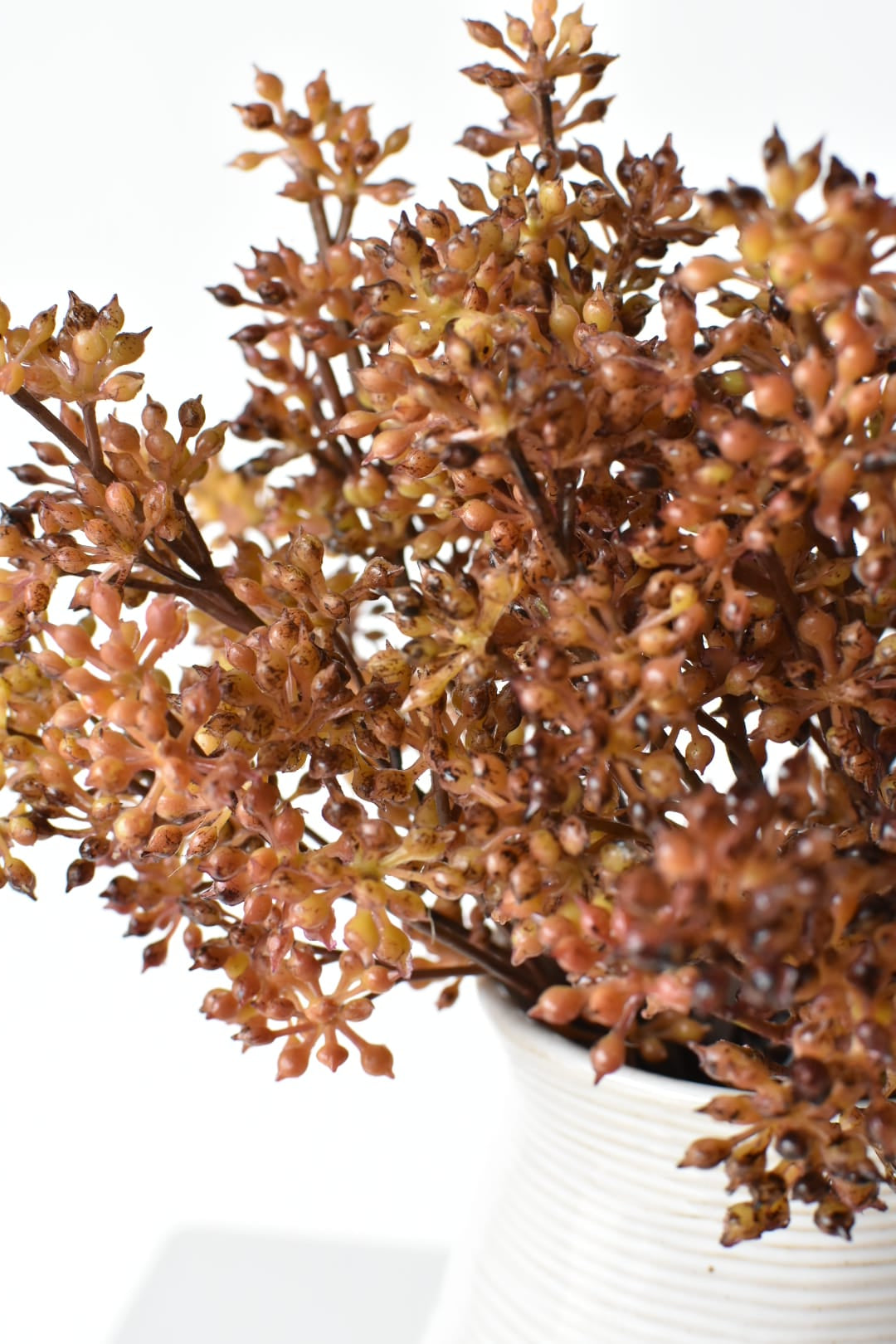 Faux amber sedum stems spread apart to show how the bundle mounds