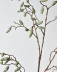 Texture detail of the molded green and gray pods on a faux branch stem