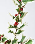 Spiky white edged holly leaves with soft points on a faux stem