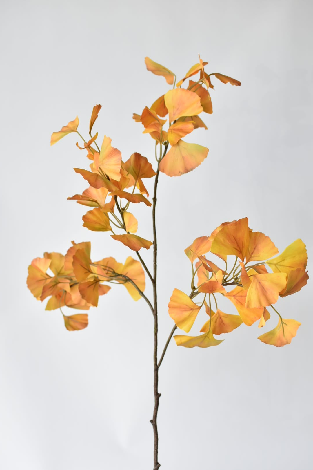 43 inch faux ginkgo stem with yellow and orange fan-shaped leaves