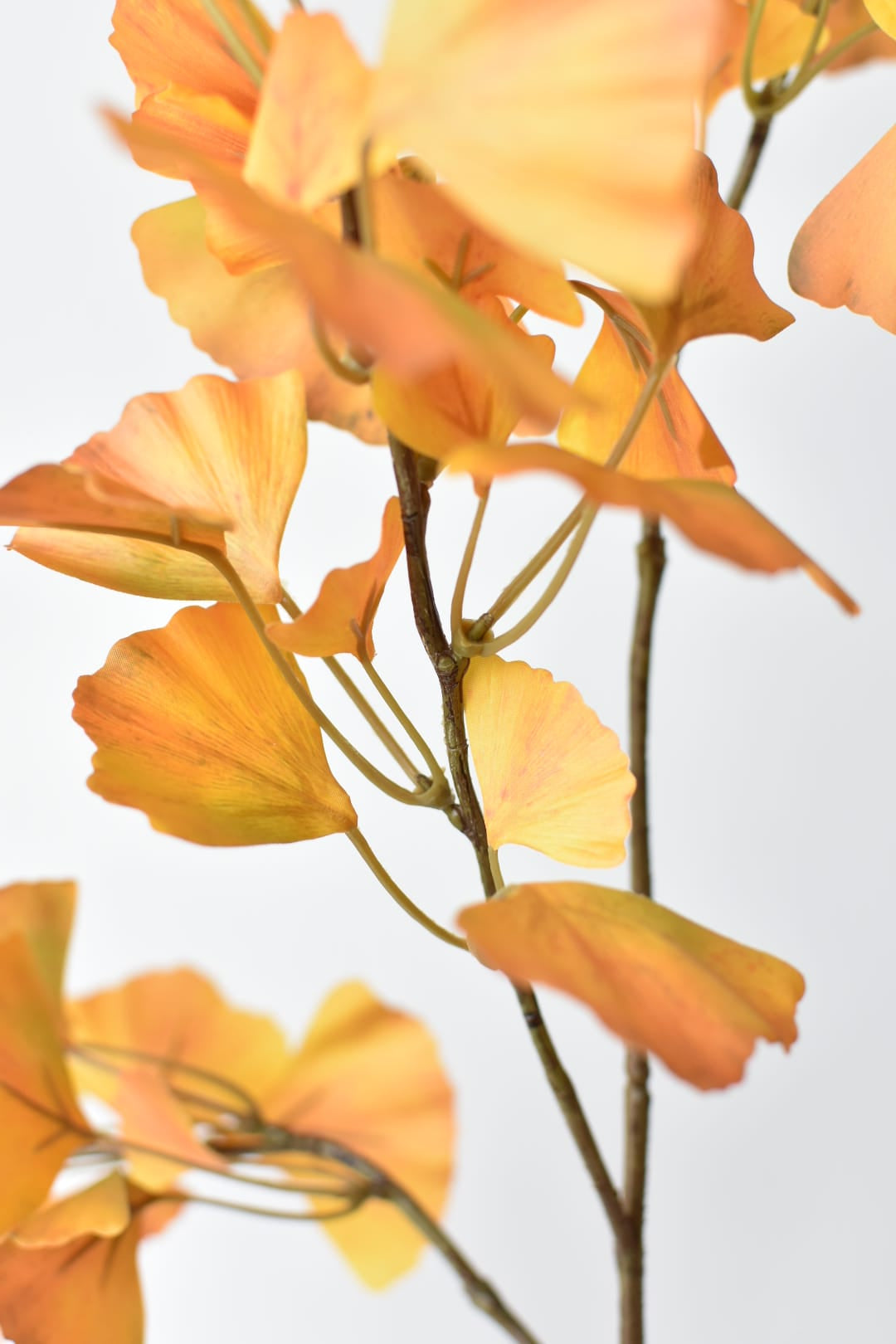Artificial ginkgo branch in yellow with a gray wash across the leaf tops