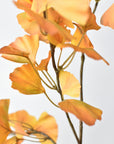 Artificial ginkgo branch in yellow with a gray wash across the leaf tops