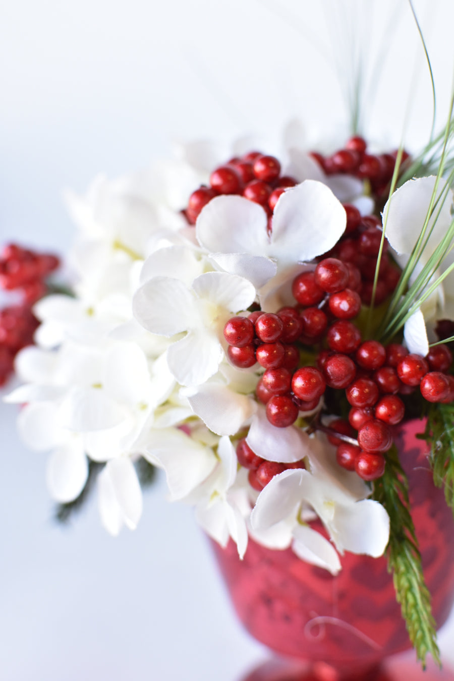 White Hydrangea + Greens in Red Glass Container