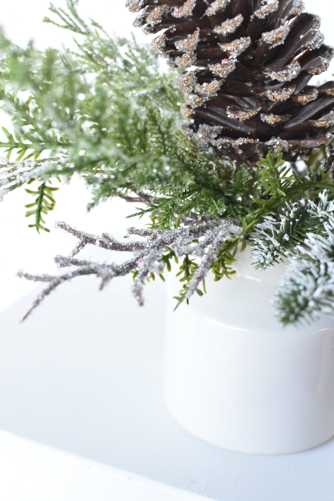 13" Iced Pinecone and Pine in White Ceramic Vase
