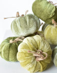 Velvet wrapped foam pumpkin with a twig stem and twine bow