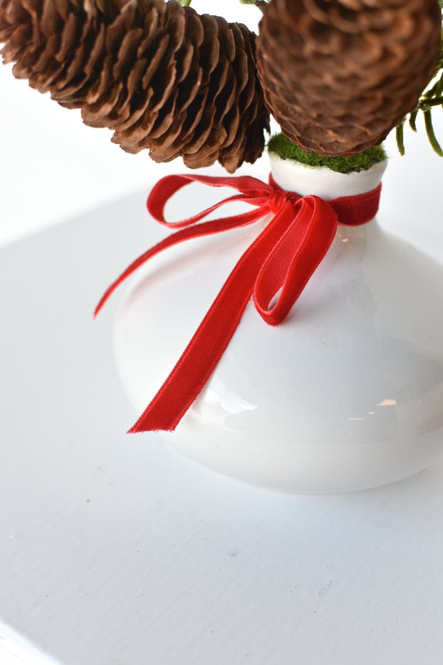 11" Faux Hemloch Stems w/Pinecones in Container with Red Velvet Bow