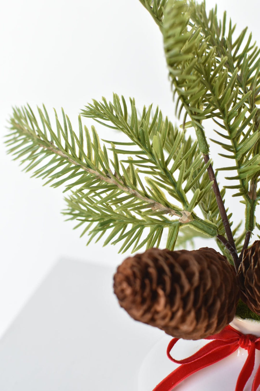 11" Faux Hemloch Stems w/Pinecones in Container with Red Velvet Bow