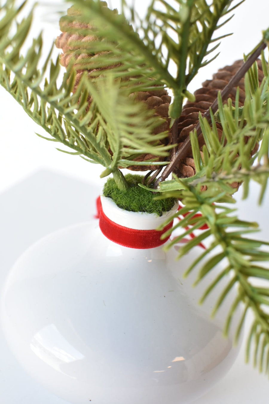 11" Faux Hemloch Stems w/Pinecones in Container with Red Velvet Bow