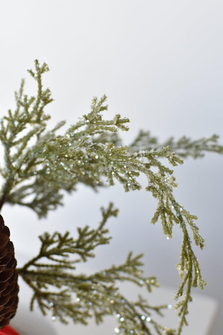 11" Faux Iced + Glittered Cypress Stems w/Pinecones in Container with Red Velvet Bow