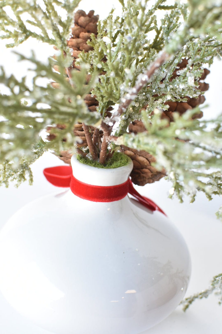 11" Faux Iced + Glittered Cypress Stems w/Pinecones in Container with Red Velvet Bow