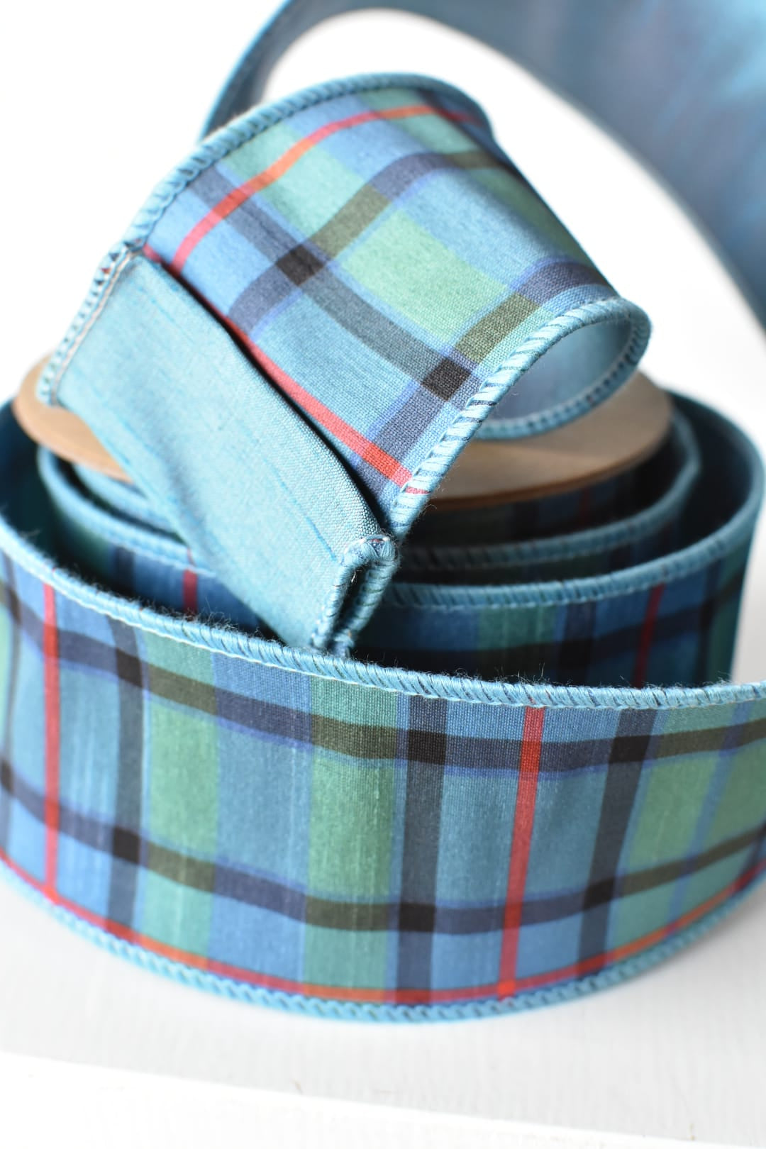 Solid blue contrast backing on a light blue plaid faux dupioni ribbon