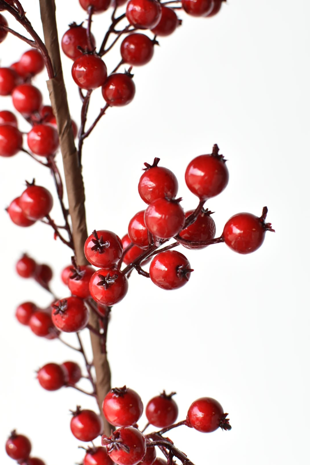 Faux red berry spray with branches that cut apart for garlands