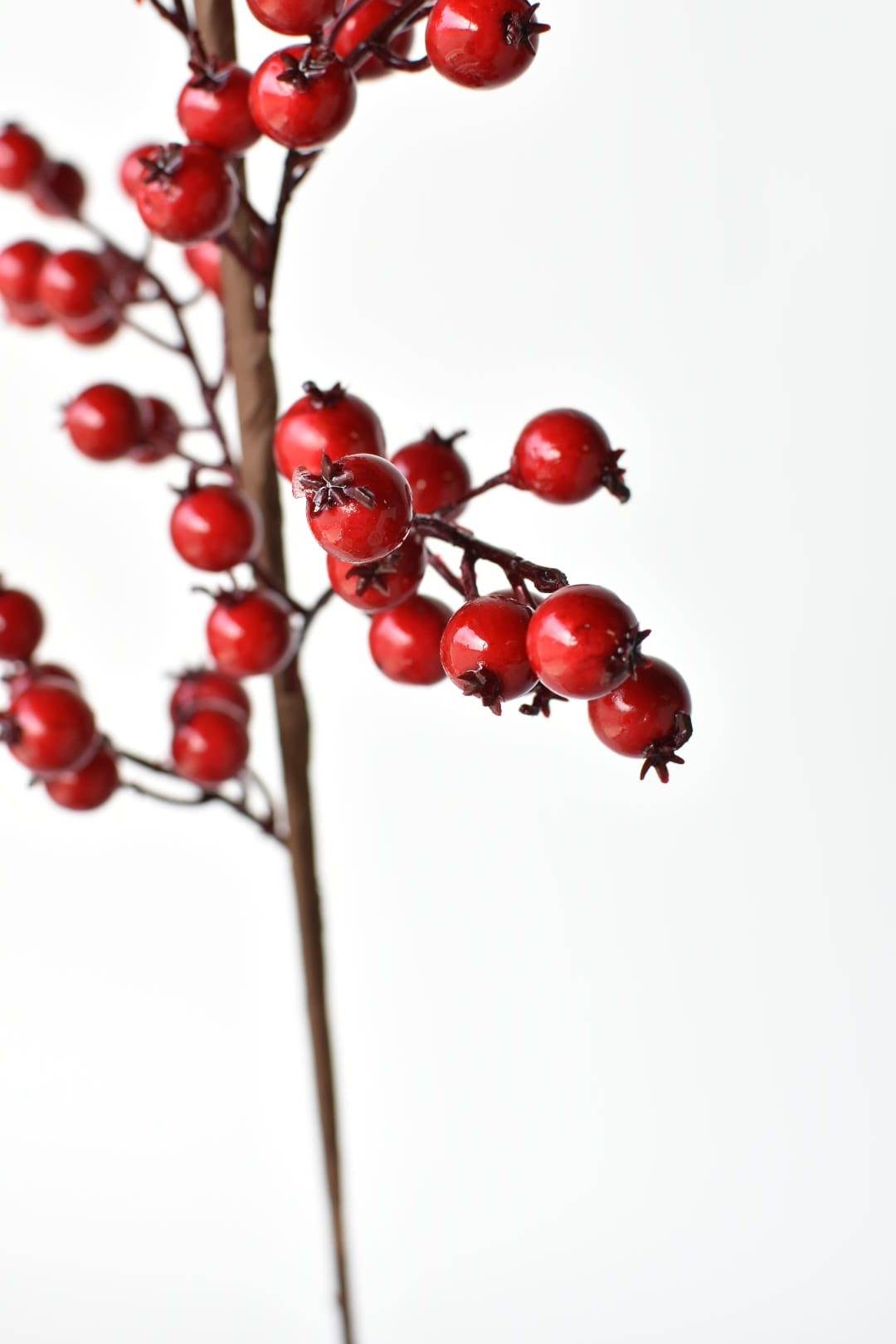 Artificial red berry branches made for outdoor porch planters