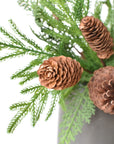 Close-up of mixed faux pine and cedar bushes filling a container