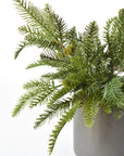 Pot filled with two artificial pine bushes for outdoor Christmas greenery
