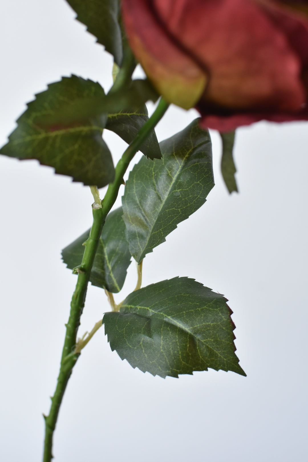 22" Faux Tea Stained Burgundy Rose Bud Spray Stem