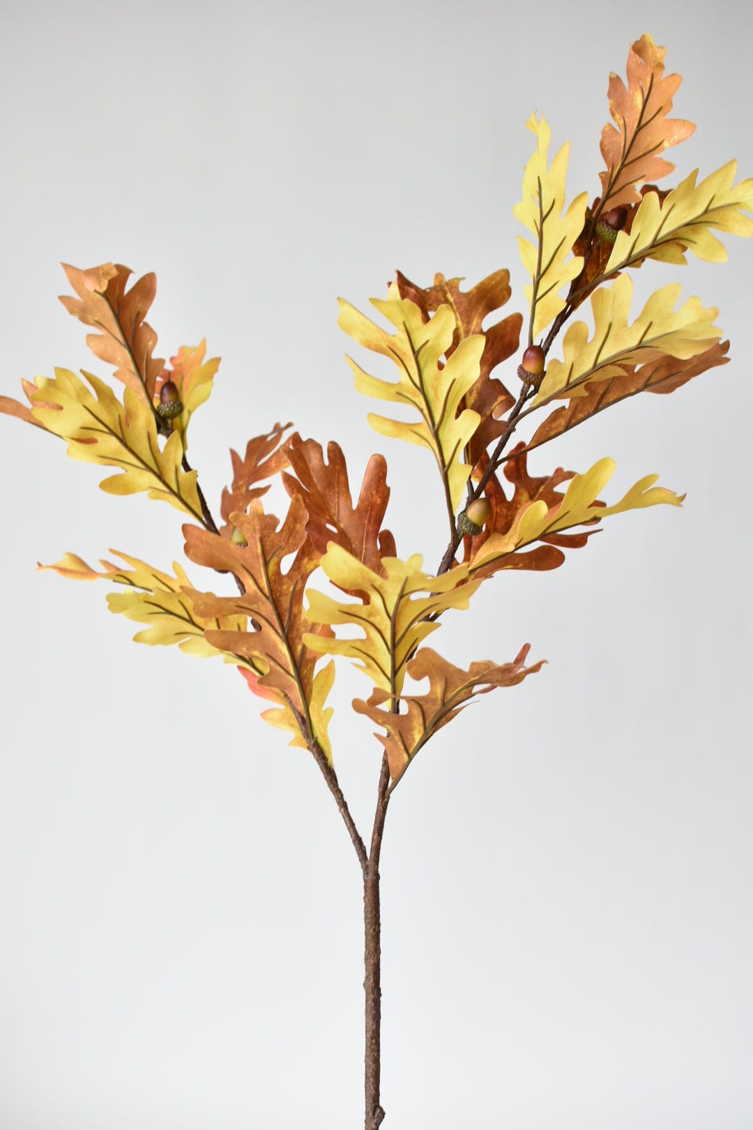 46-inch faux oak leaf branch with orange, yellow, and brown fall leaves and acorns