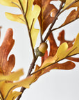 Close-up of orange and yellow faux oak leaves with acorns