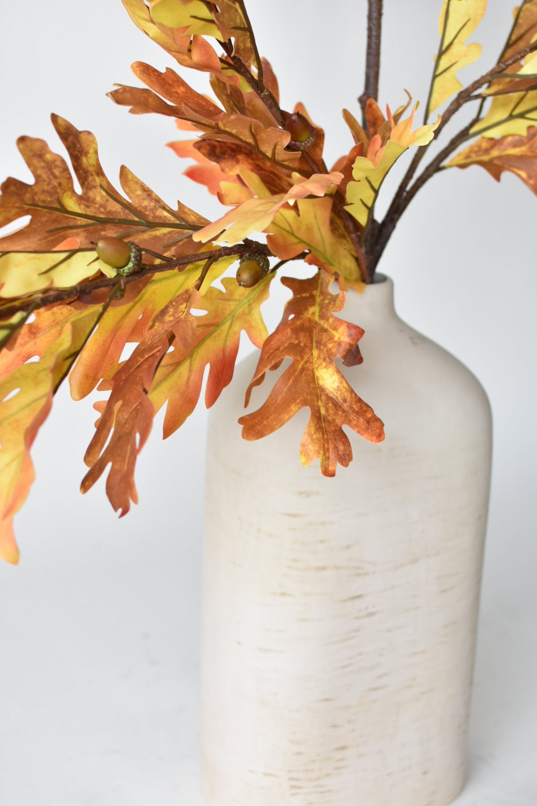 Faux oak leaf branch in warm autumn colors