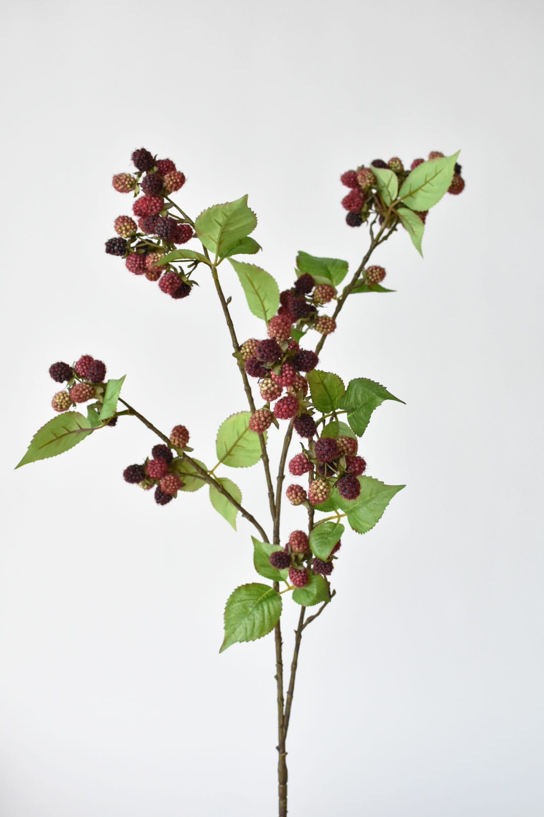 Close-up of faux raspberries showing fine red fibers on the fruit